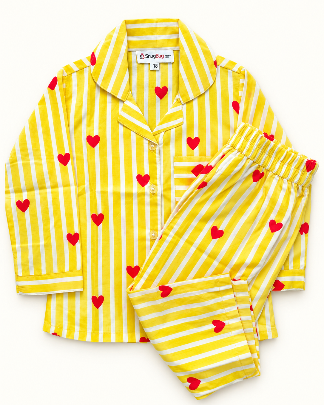 A two-piece children's pajama set featuring a yellow and white striped long-sleeve shirt and matching pants, both decorated with small red hearts. The shirt has a collar, button-down front, and a chest pocket from Aruvo