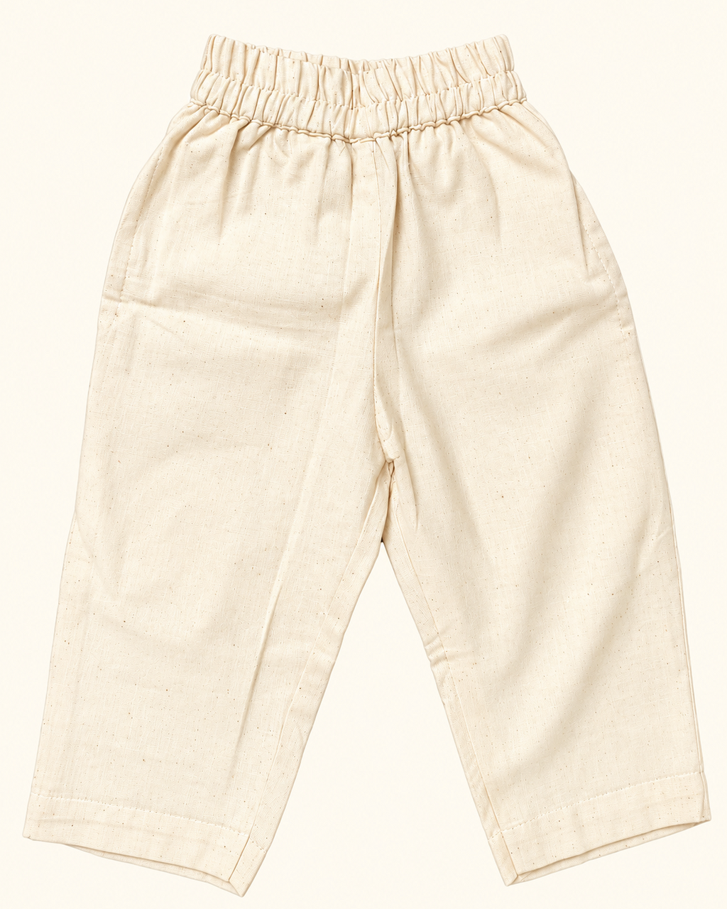 A beige colored full pant has elasticated waist with 2 pockets
