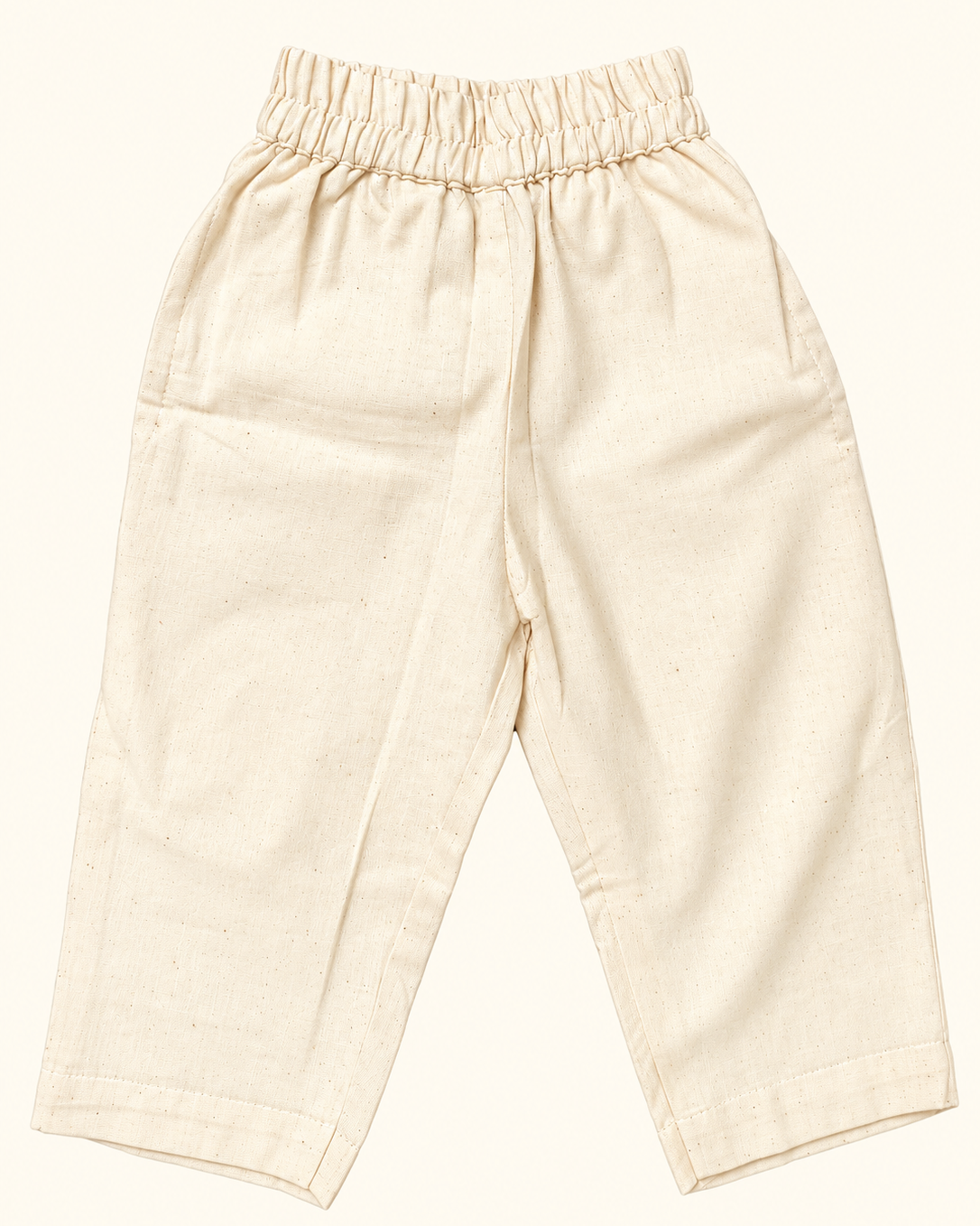 A beige colored full pant has elasticated waist with 2 pockets