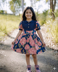 a little girls is wearing SnugBug Pure Cotton Summer Frock in navy blue color