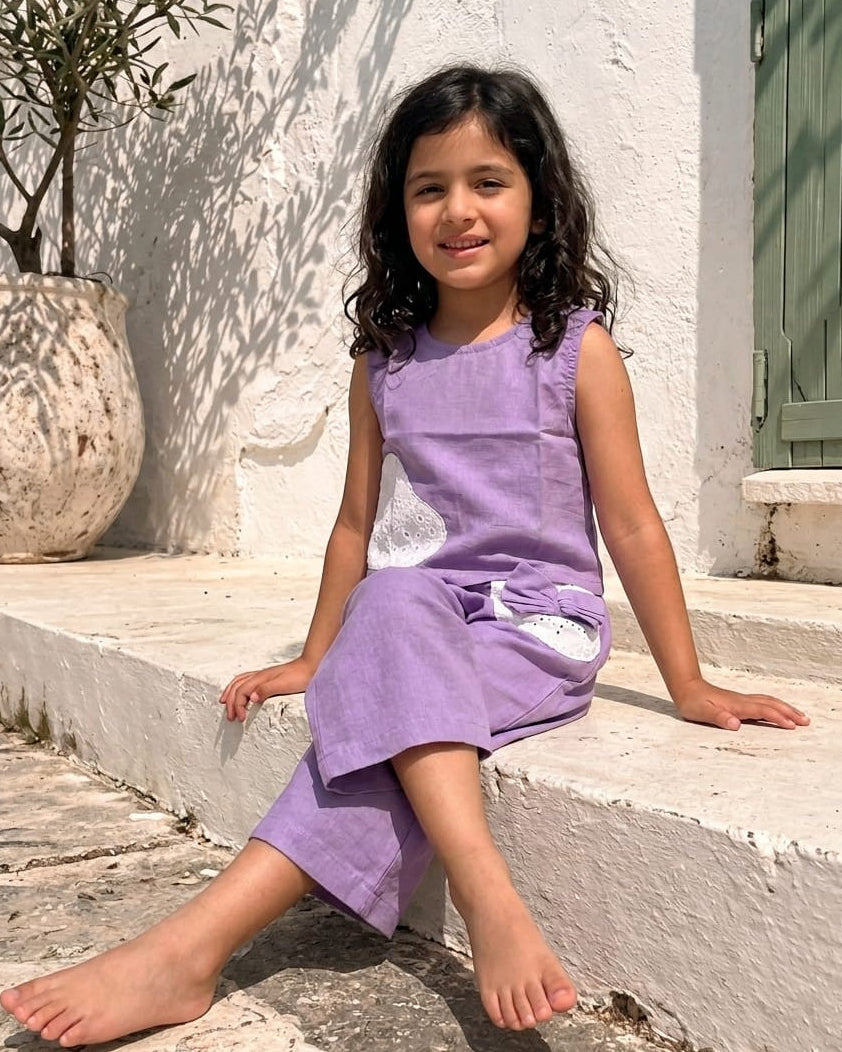 A girl wearing lavender color kids matching outfit sets for girls