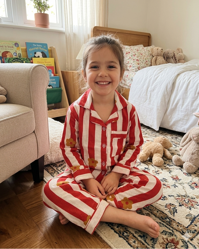 A girl wearing a striped Red and White Premium Cotton fabric Full Sleeve Night Suit Set